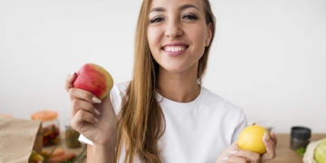 mujer feliz comiendo frutas para adelgazar